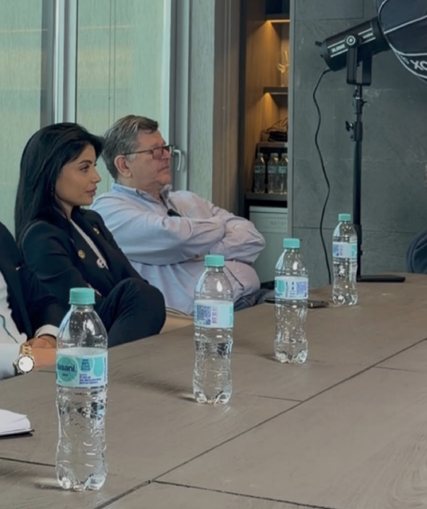 Stasia seated at a panel during a business event